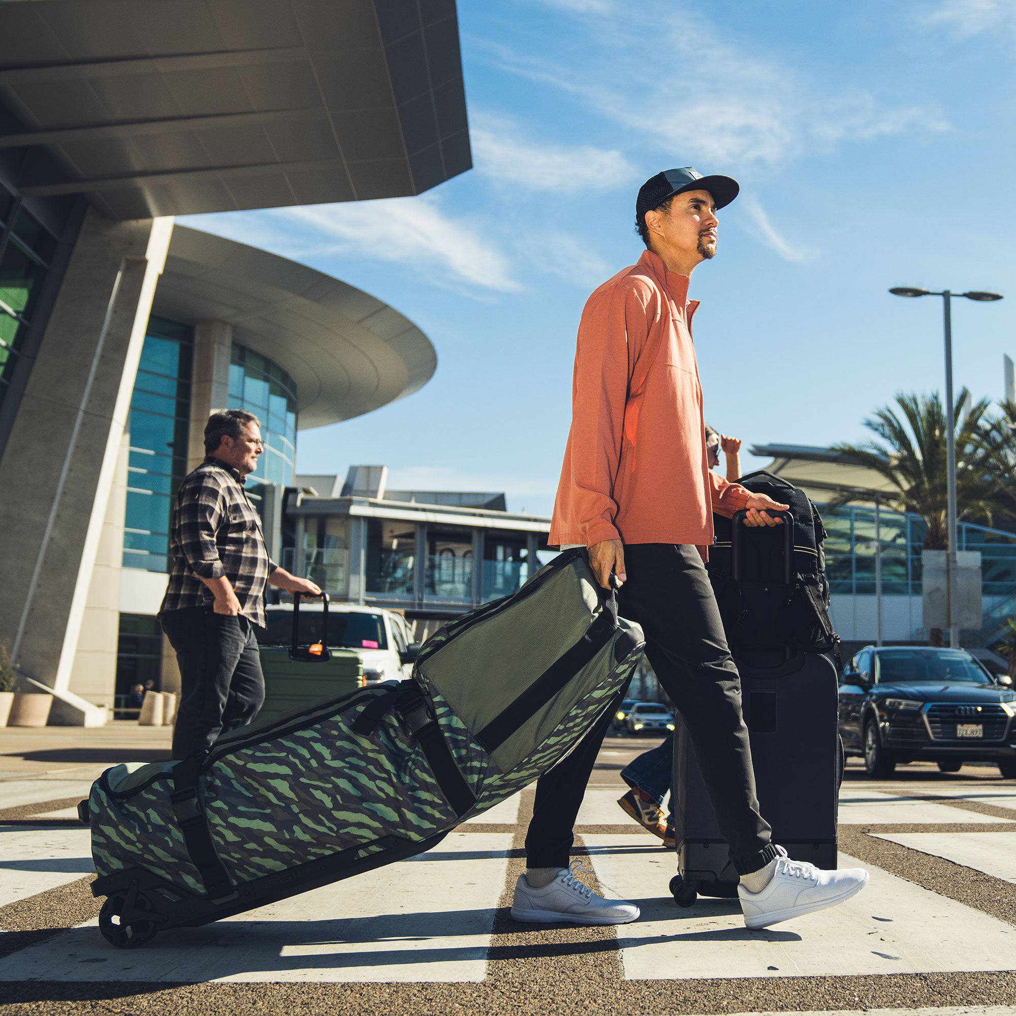 man at airport with golf travel bag